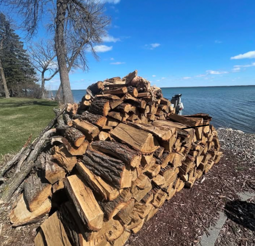 Lakefront property work with stacked firewood